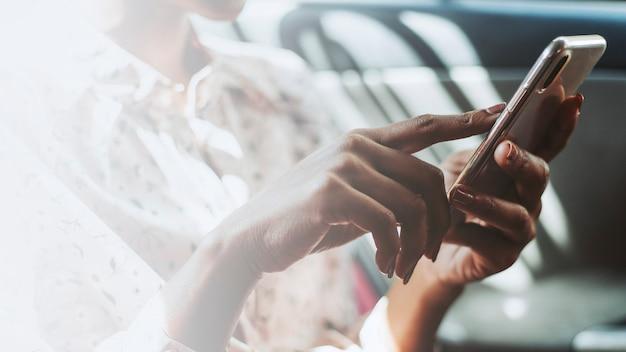 Woman using a phone in a car