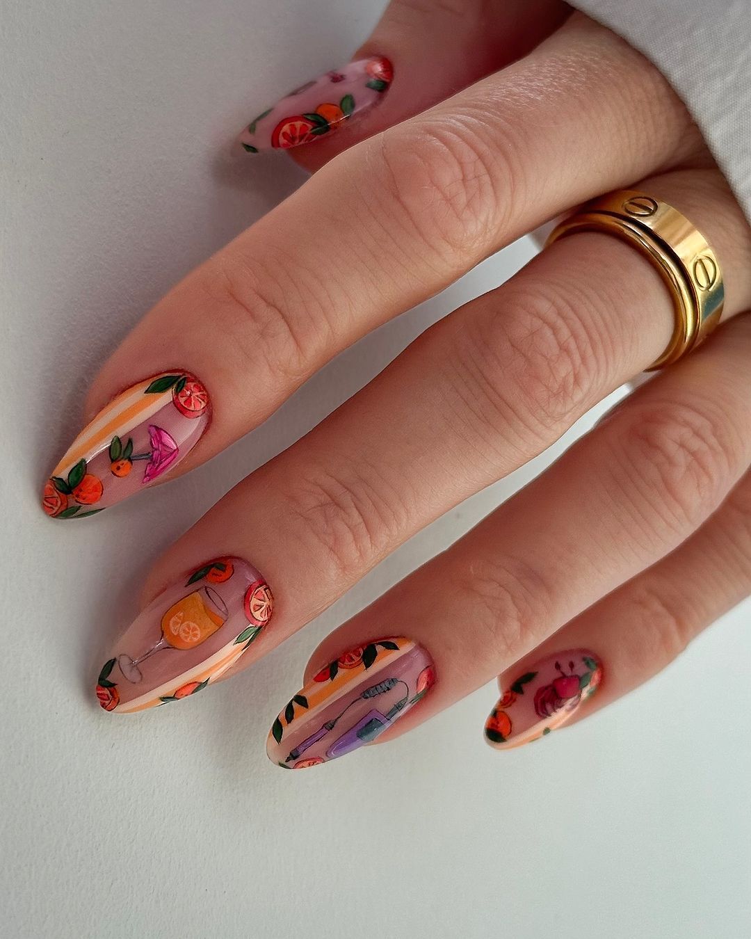 Close up of nails with glittery orange nails having Stamping for Orange Patterns