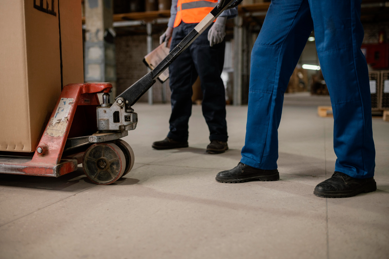 Worker using a trolley for industrial ergonomics.