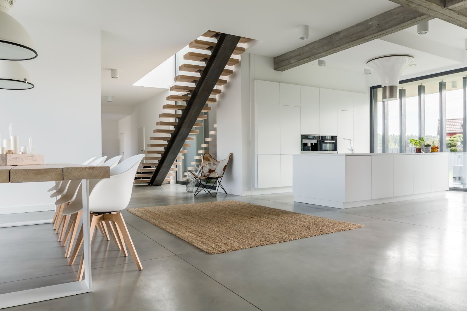 Open floor plan home with a kitchen, dining room, and stairs visible. 