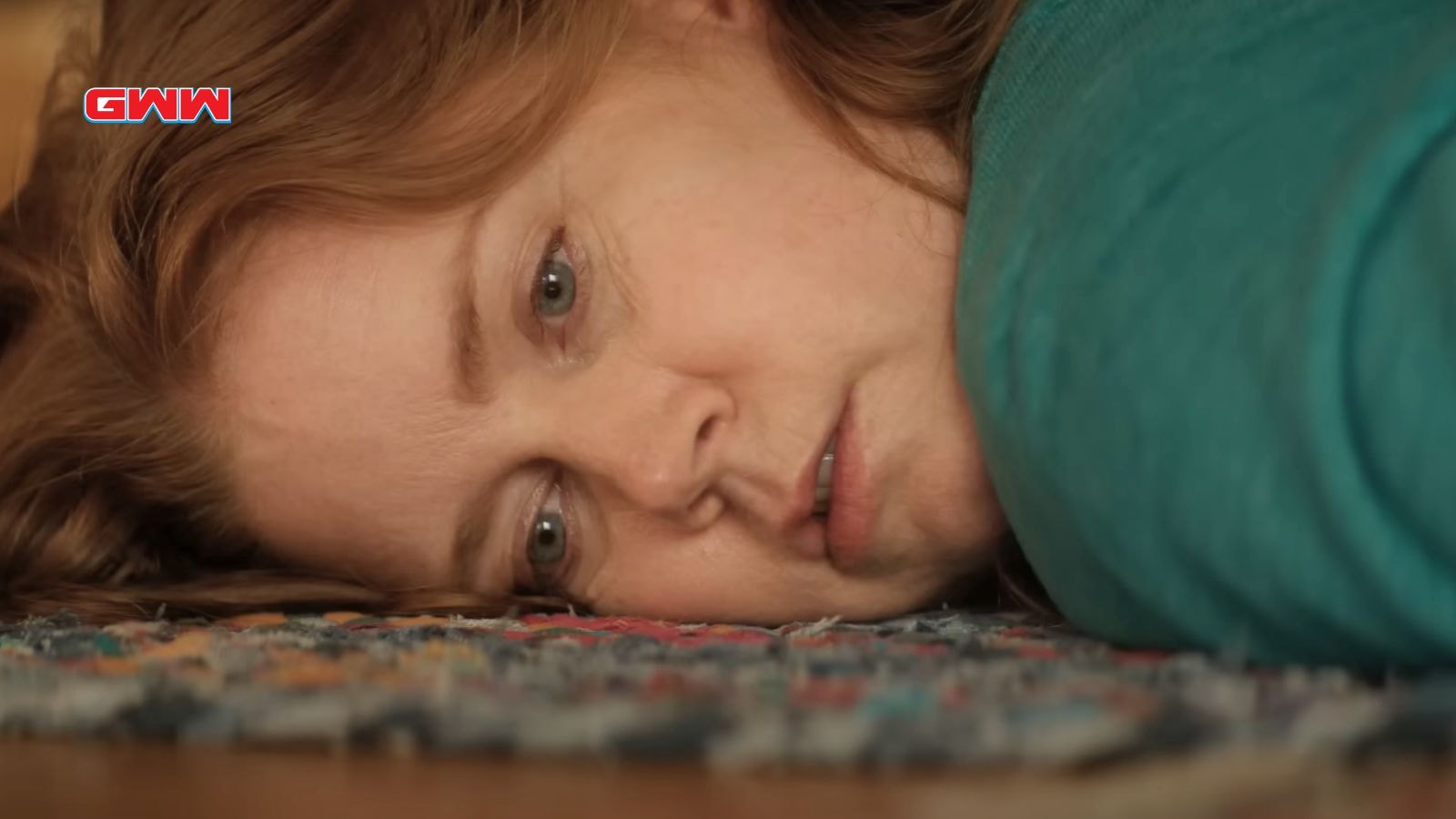 Close-up of Amy Adams lying on the floor, looking introspective.