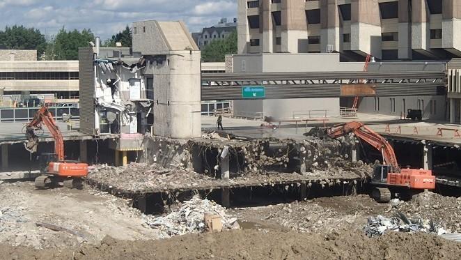 A cast-in-place concrete  post-tensioned garage under demolition