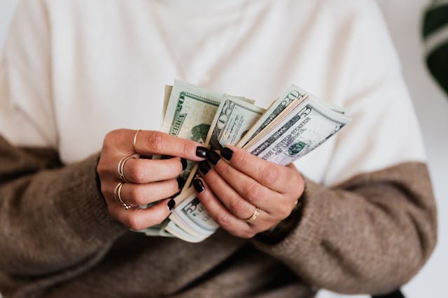 Someone counting a stack of money