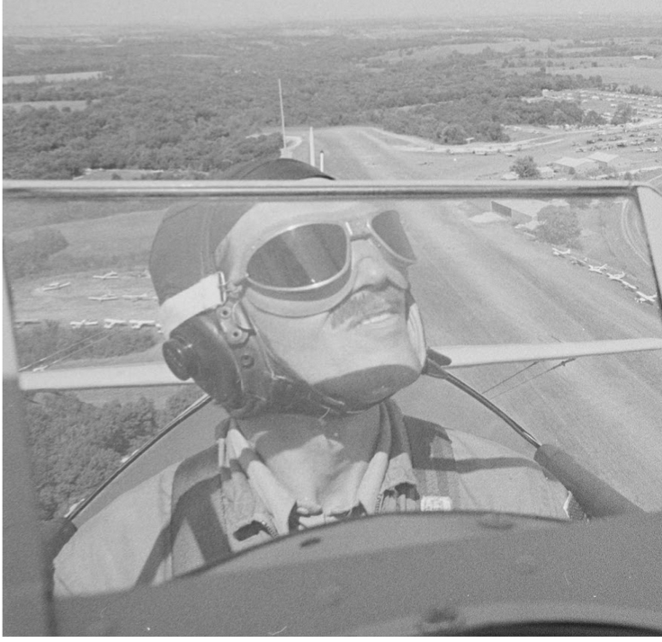 The same pilot photo cropped close around the pilot, so the expanse of surrounding fields in the background is no longer shown