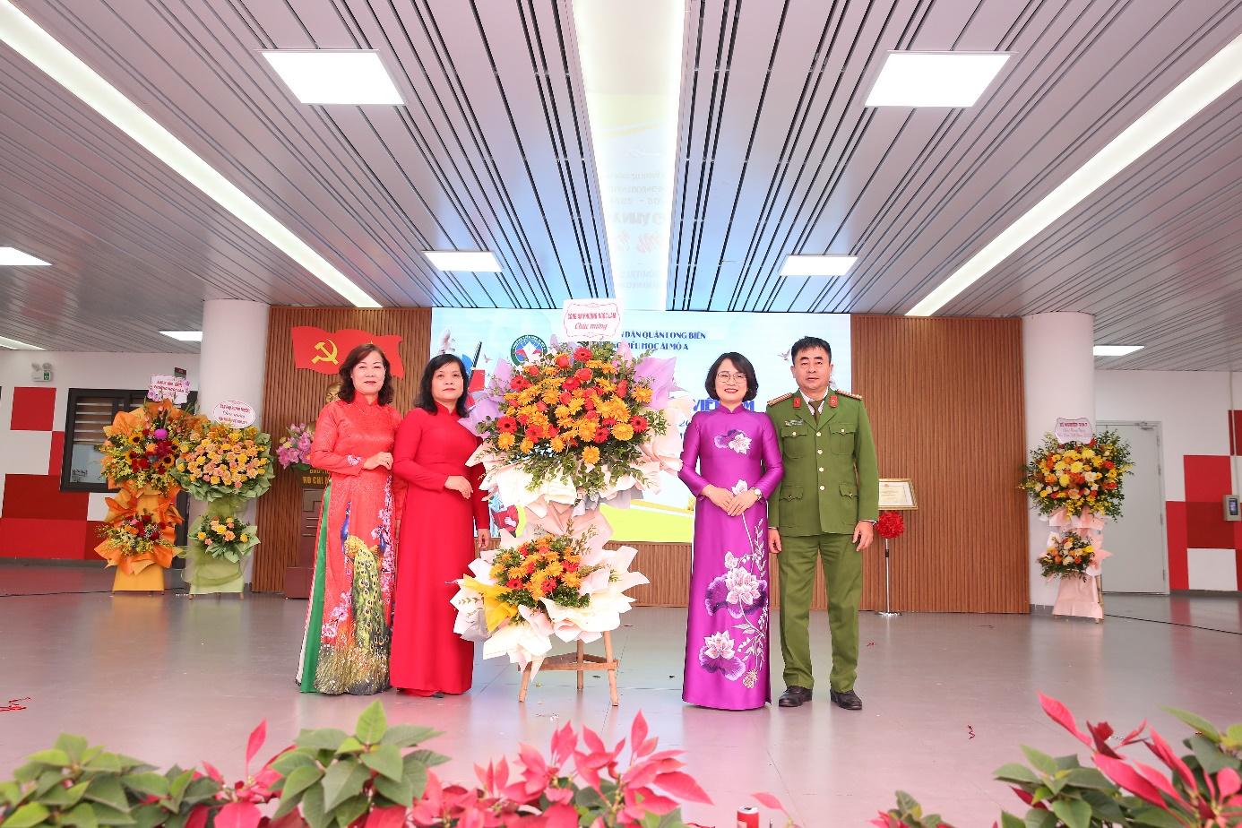 A group of people standing in a room with flowers

Description automatically generated