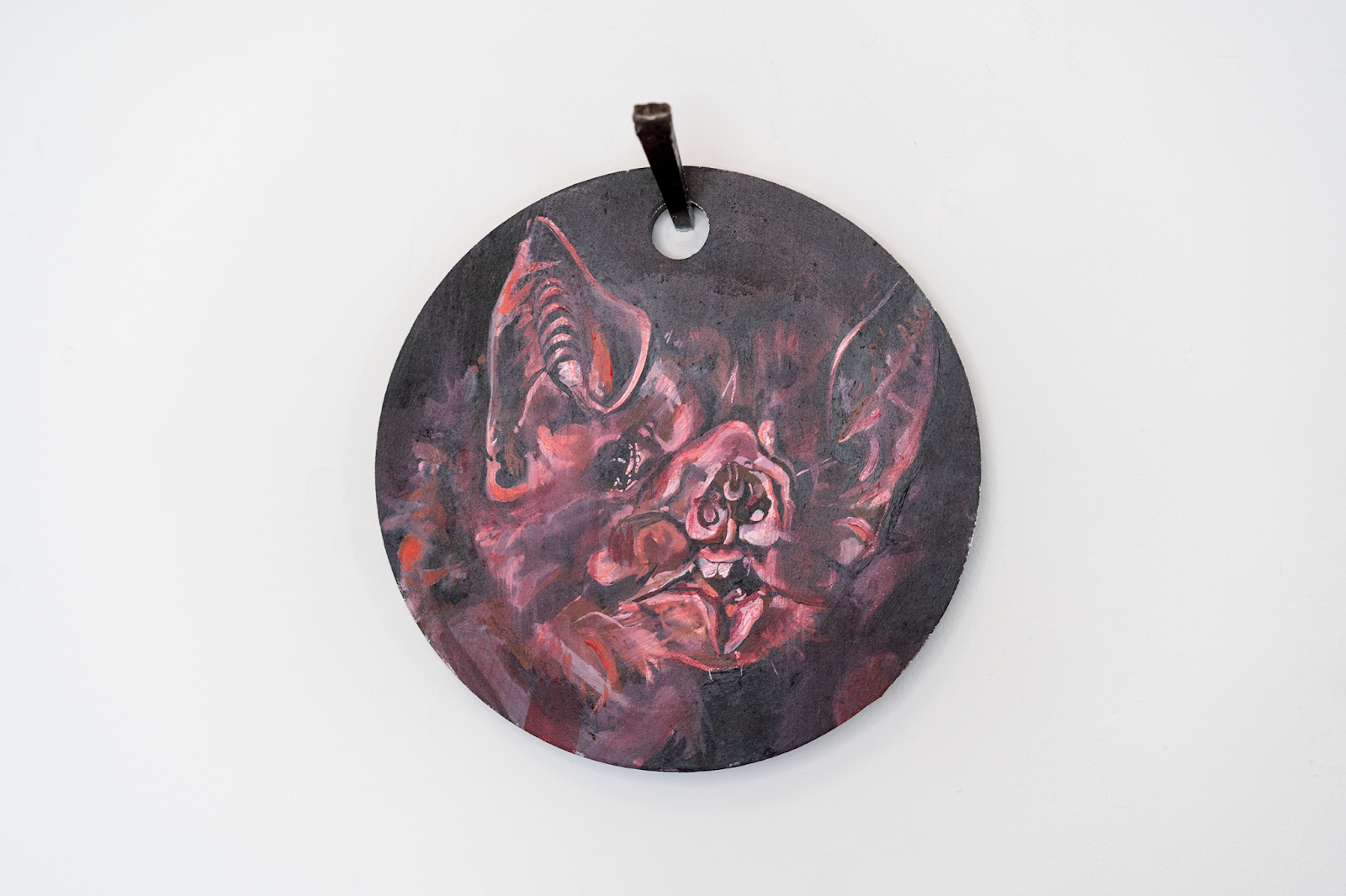 Image: D Rosne, —what is it like [for a Bat] to be a Bat?, 2024, gouache and iron paint on steel shooting target, 8 diameter x 0.5 in., 20.32 x 1.27 cm. A Vampire Bat is painted orange, pink, red, blue, yellow, green, brown, magenta, and black on a steel shooting target. Photo: Levi Shand, Grant: DCASE, 2024