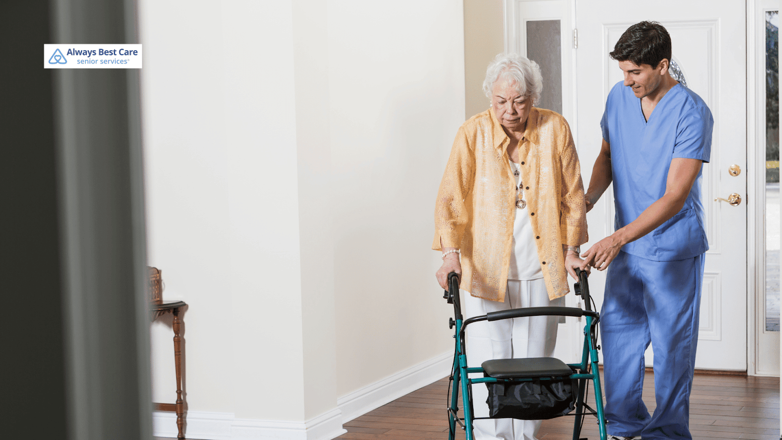 This image depicts a caregiver helping a senior woman walk with a walker