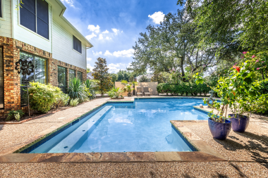 signs your outdoor living space is ready for a remodel pool with stone concrete and stone deck custom built michigan
