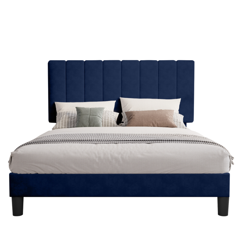 A stylish piece of home furniture featuring a bed with a navy blue, vertically paneled headboard and matching frame. The bed is dressed in light-colored bedding with multiple pillows in neutral tones, creating a clean and modern aesthetic.