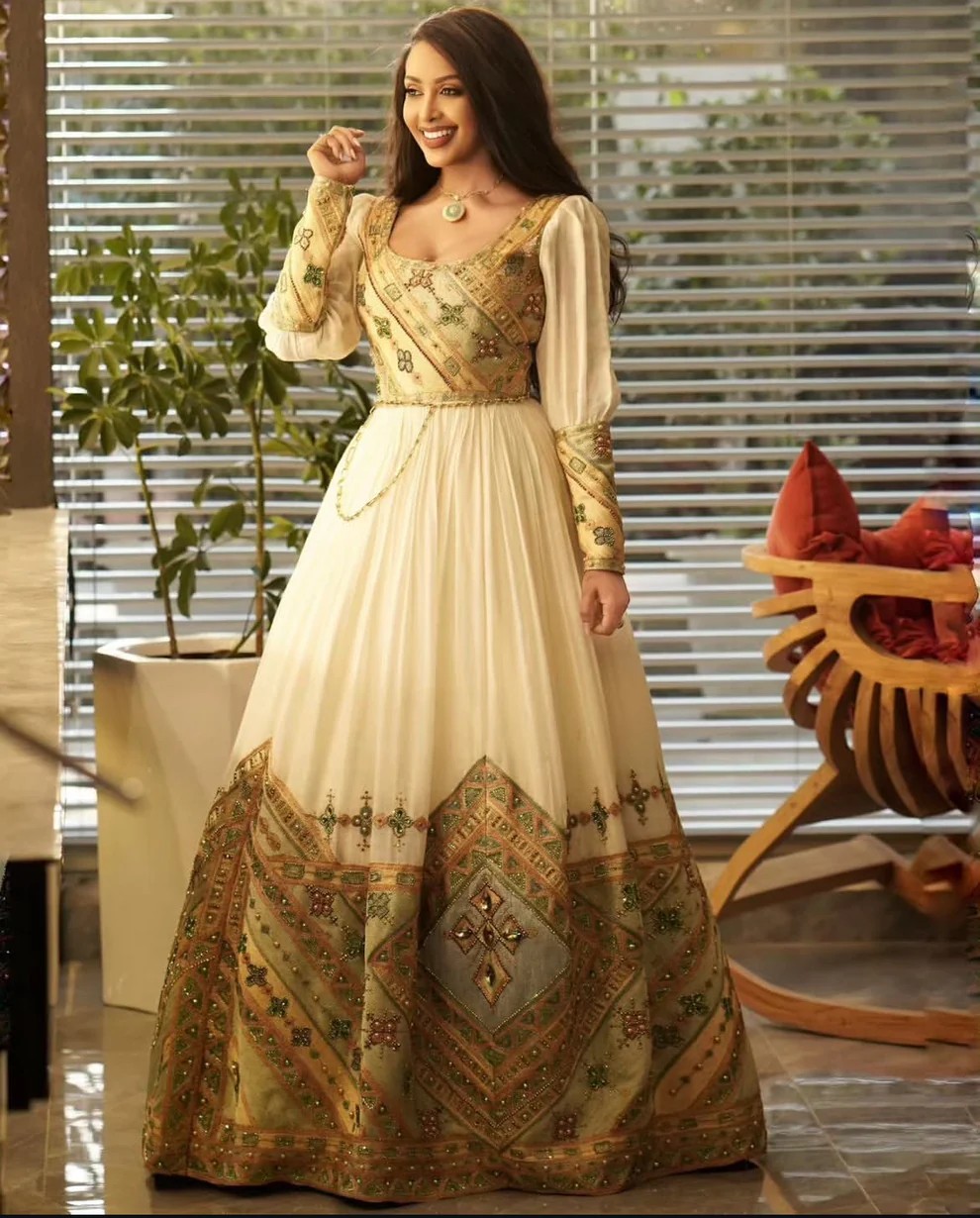 Woman wearing a classic Habesha kemis with intricate gold embroidery, representing cultural elegance for diaspora weddings