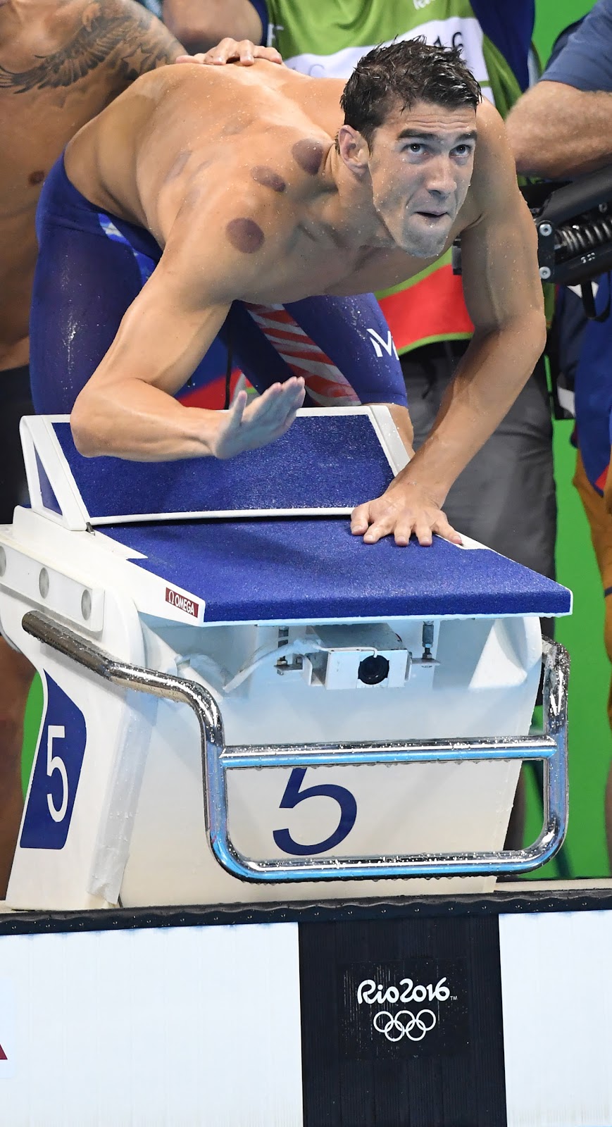 Michael Phelps cheers teammate Nathan Adrian as he swims the last leg of the 4X100-meter freestyle relay at the Rio Games, on August 7, 2016. | Source: Getty Images