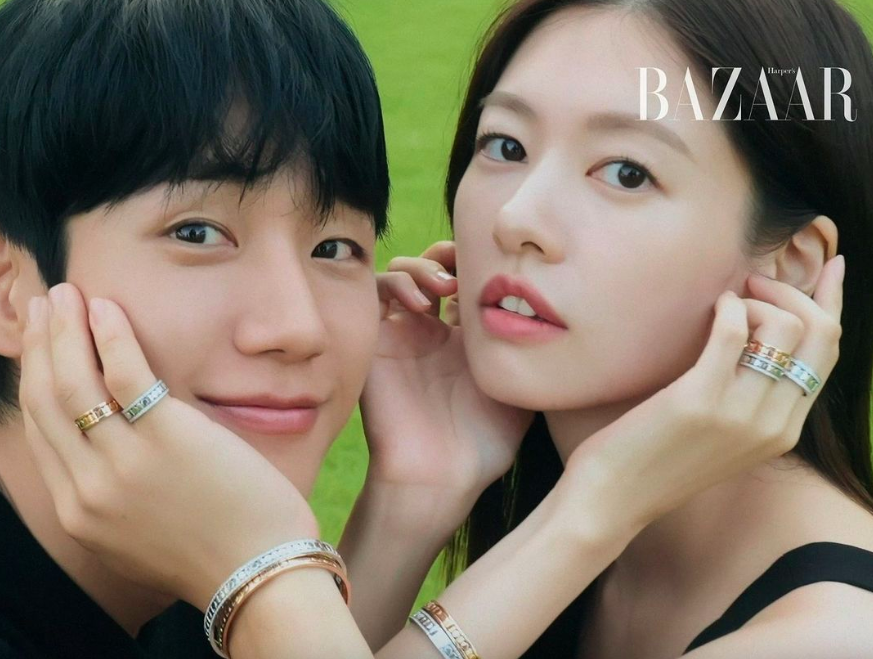 This contains an image of  Jung Hae In and Jung So Min taking a photoshoot for Harper's Bazaar 