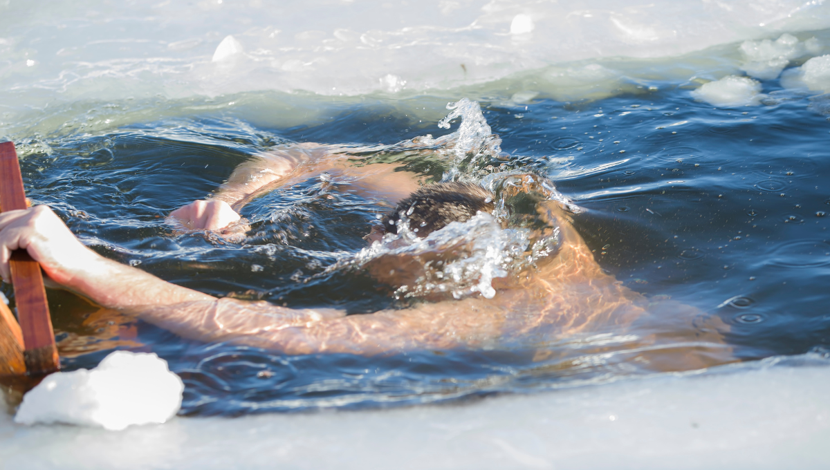 Person under iced water in a lake.