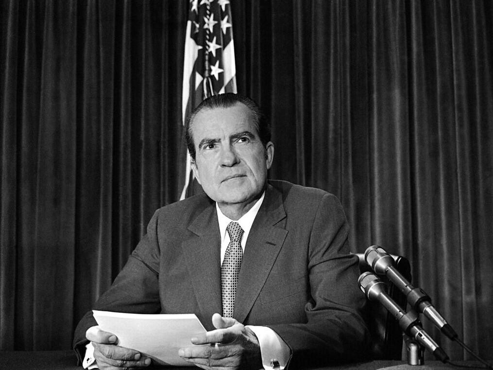 A black and white image of Richard Nixon launching the war on drugs, ceasing all psychedelic research.