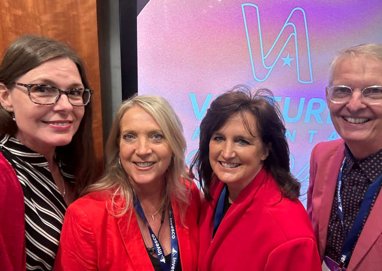 A group of women posing for a photo
Description automatically generated