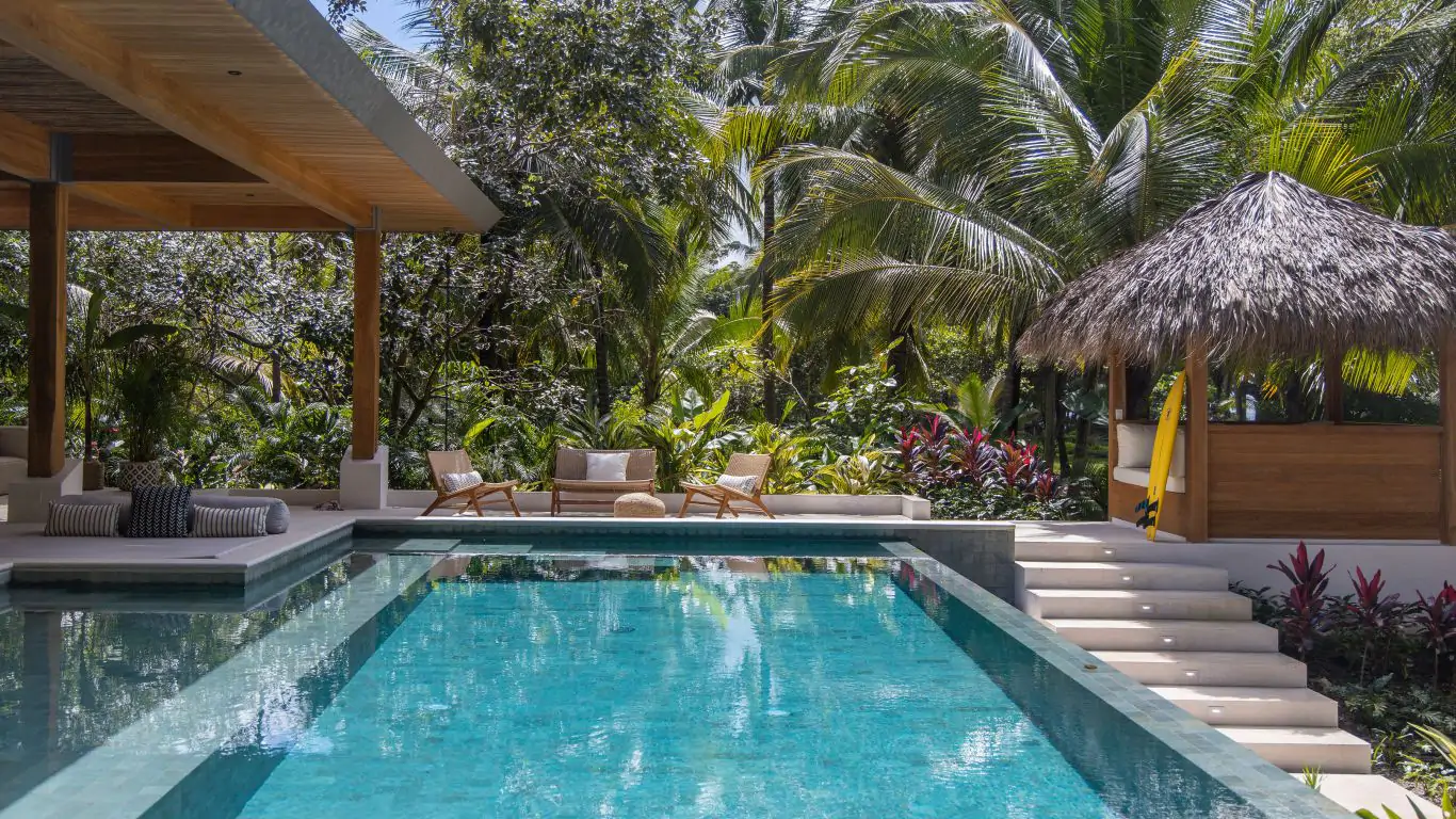 Luxury villa in Santa Teresa with a private pool, tropical garden, and shaded lounge area near Playa Santa Teresa.