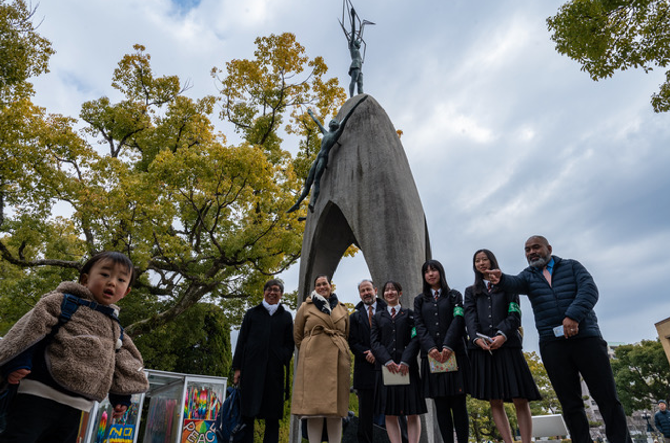 A young friend joins Daryl Kimball and the NGO delegation at the Children's Monument for Peace to commemorate the life of Sadako Sasaki and the thousands of child victims of the 1945 atomic bombing.