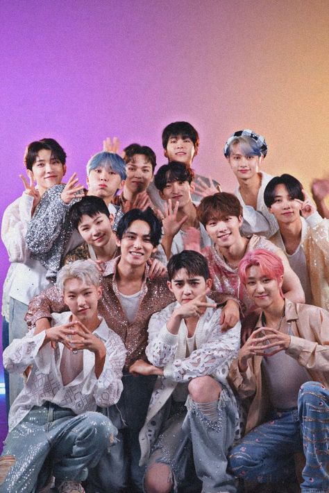 This contain SEVENTEEN posing for a photo in front of a purple and blue background