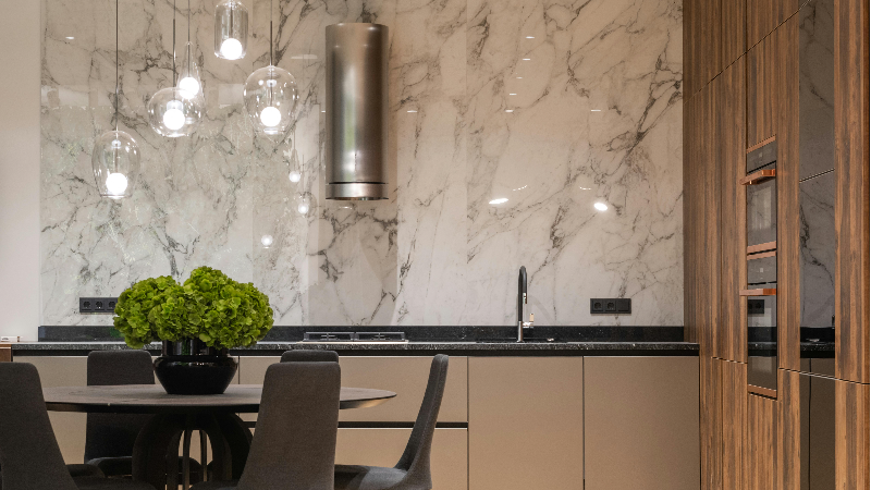 A beautifully illuminated kitchen with a fancy chandelier 