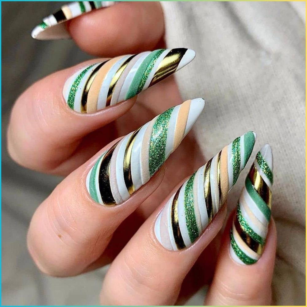 Close up of hands with Christmas Green Nails having  Green & White Candy Cane Stripes