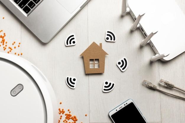 Top view of wi-fi router with house figurine and wireless controlled devices