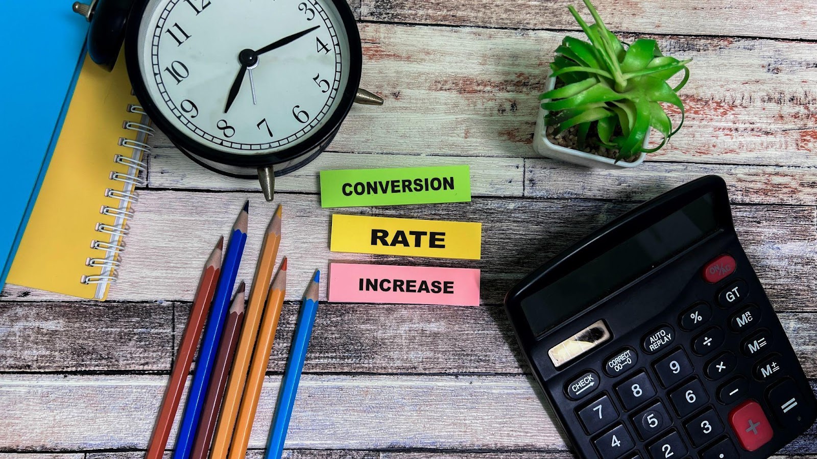 Table showing different items and post-it notes showing conversion rate increase