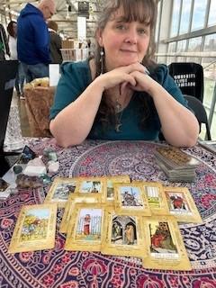 A person sitting at a table with cards Description automatically generated