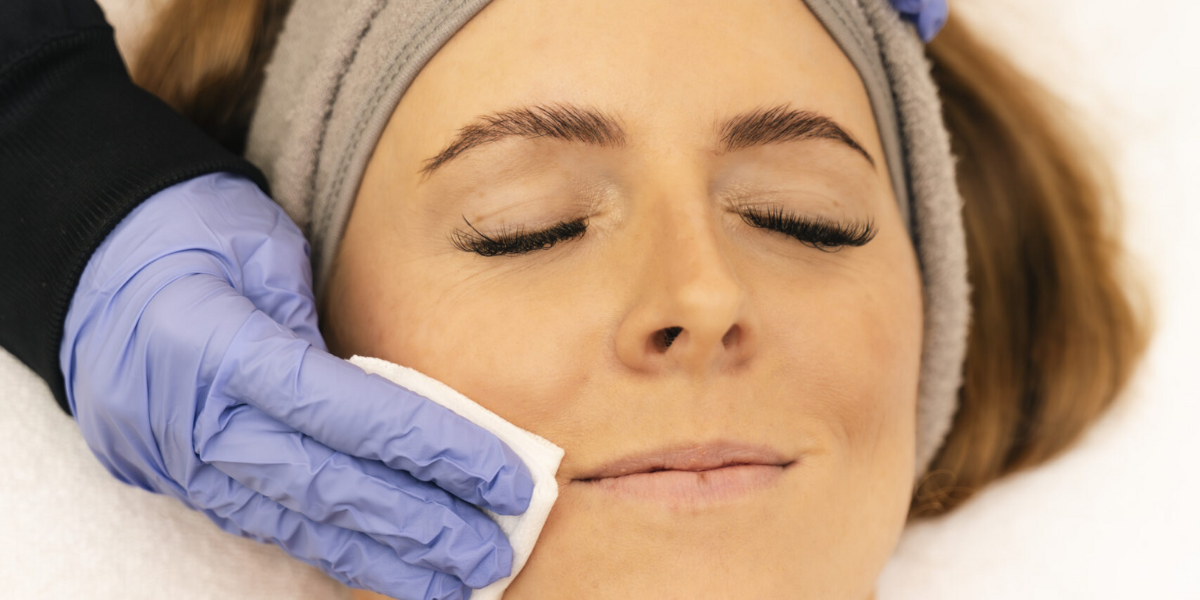 A woman receiving a facial treatment, enjoying a Hydrafacial for skin rejuvenation and hydration.