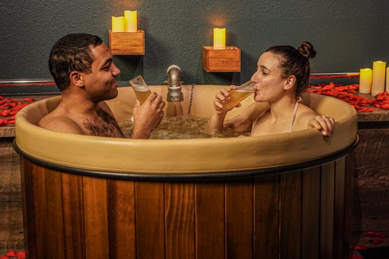 couple taking a beer bath at Oakwell Beer Spa, one of the most romantic places in Denver