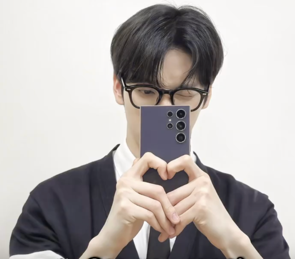 A picture of MOAs holding  a phone with his two hands 