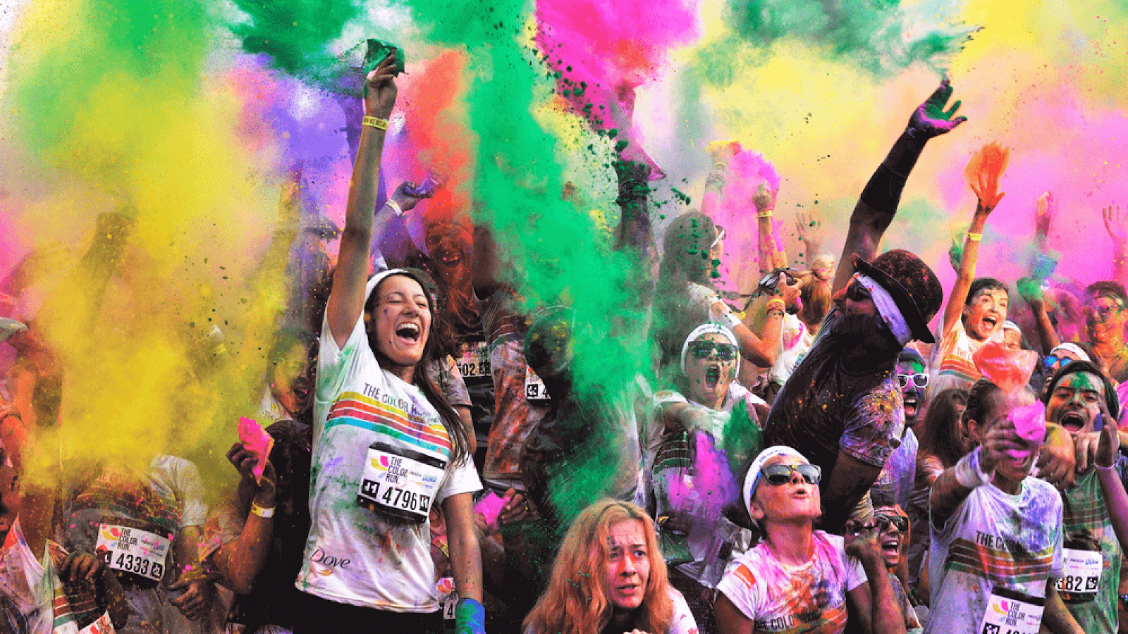 Runners celebrate completing a color run