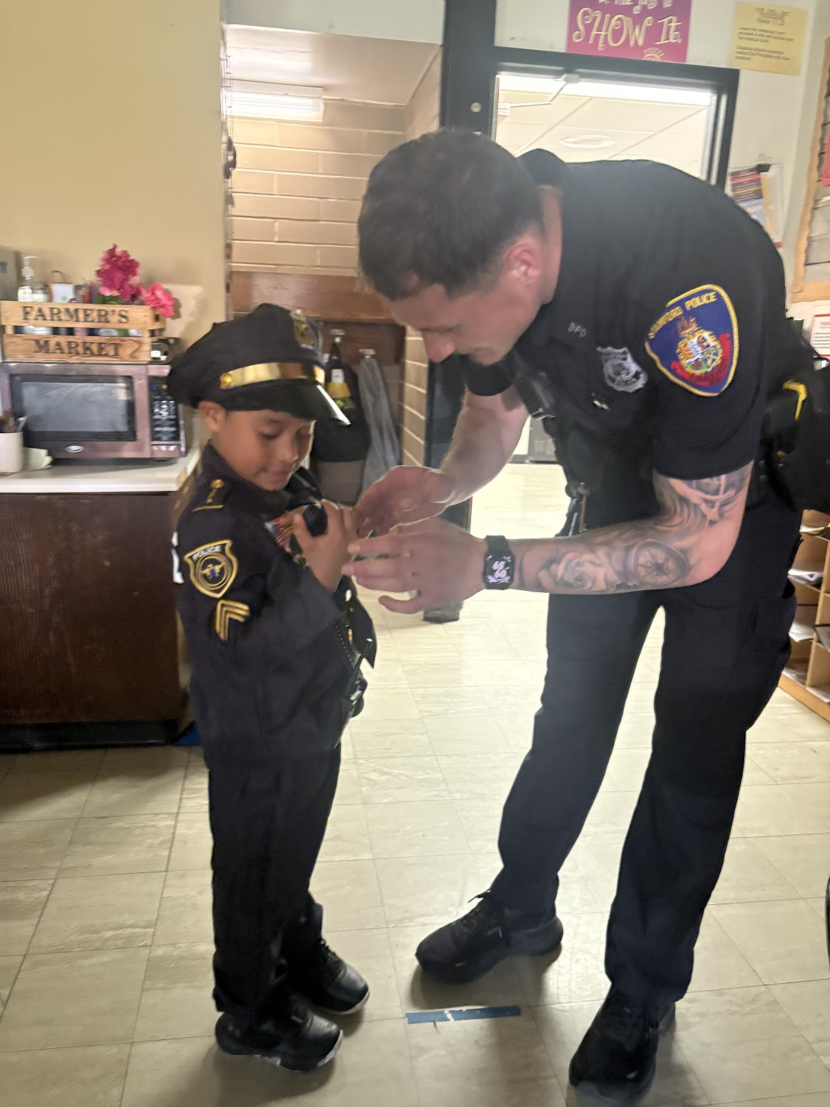 Toquam student dressed as a police officer with a member of Stamford PD