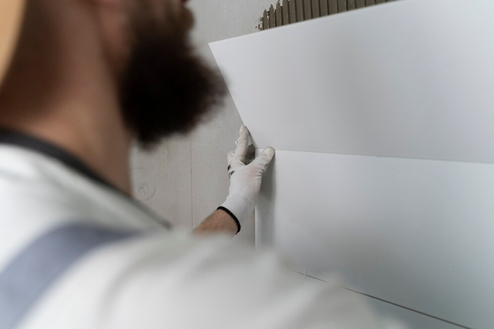 man installing backsplash