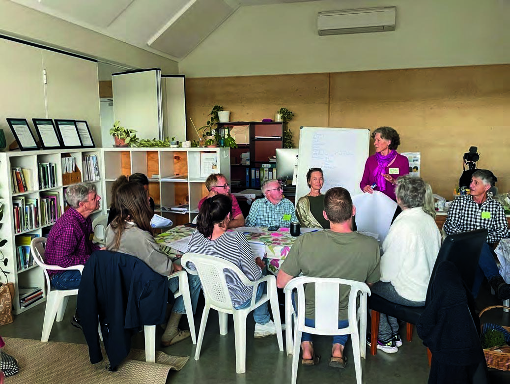 A group of people sitting around a table

Description automatically generated