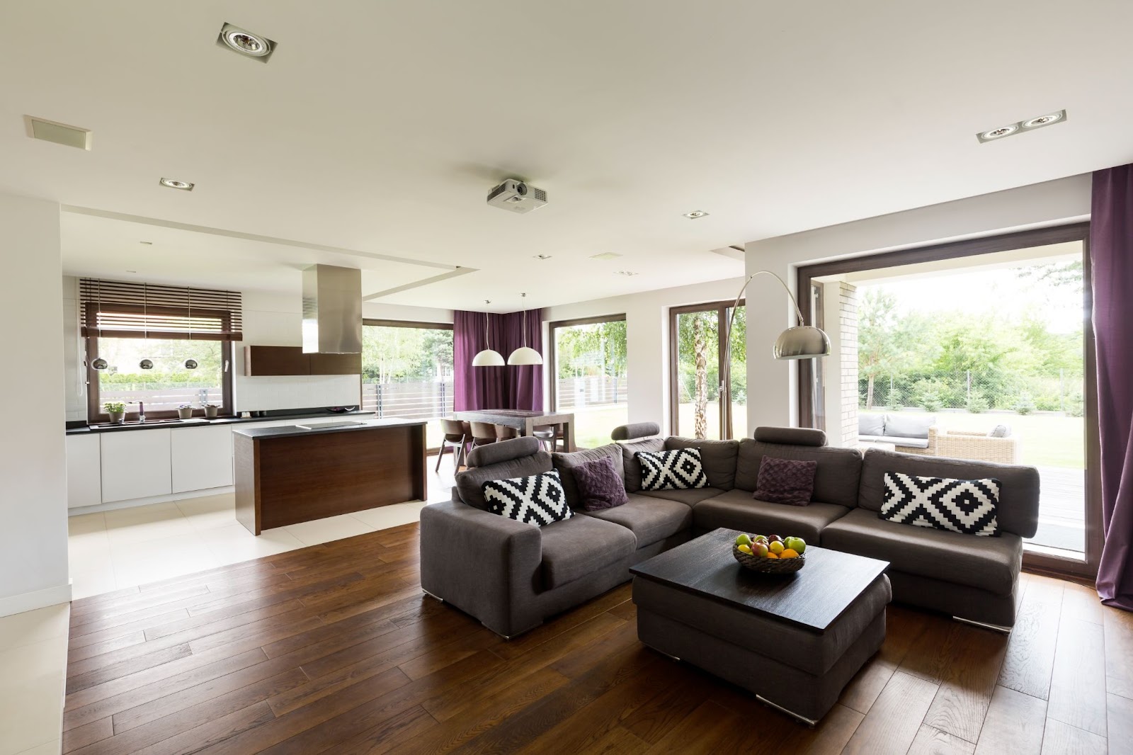 Modern home with a living room, dining room, and kitchen visible. 