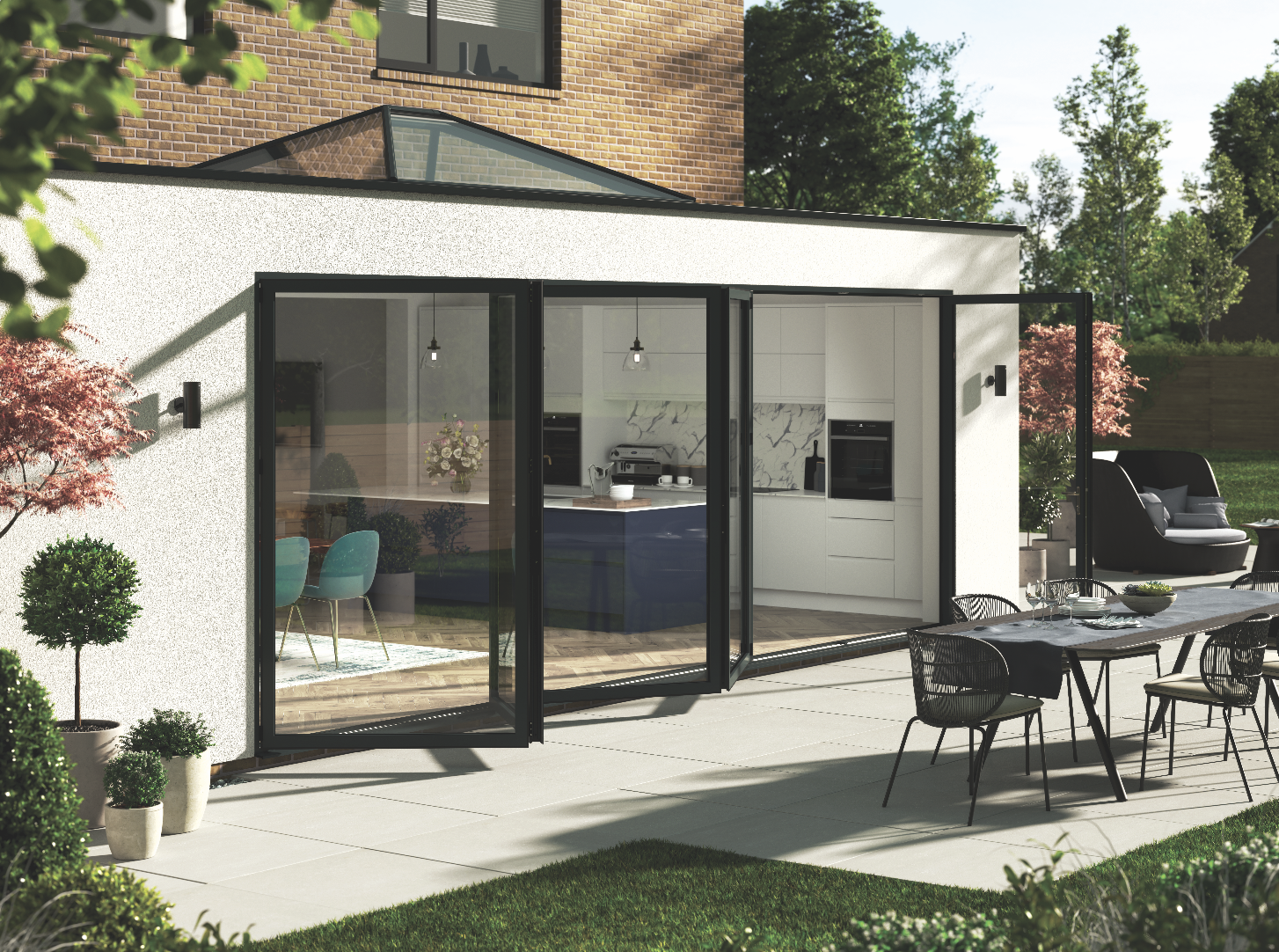 Bifold doors: A black aluminium Korniche bifold door opens out onto a patio in the sun 
