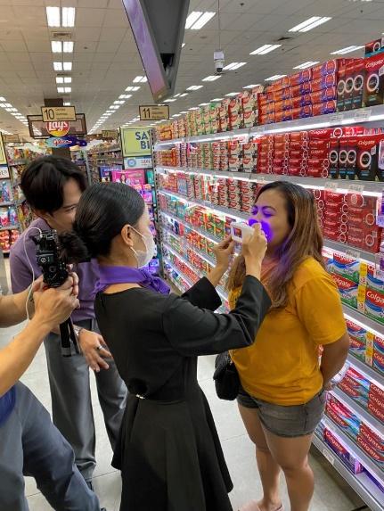 A person with purple eyeshadow and purple makeup in a store

AI-generated content may be incorrect.