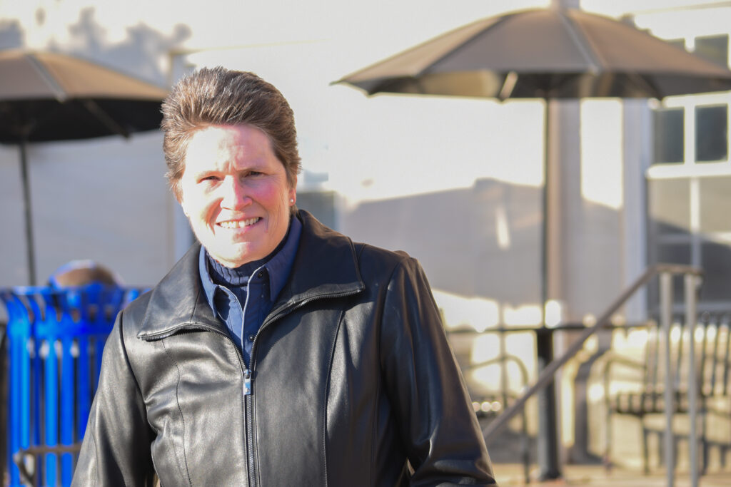 Woman in a black jacket on an apparently cold day.