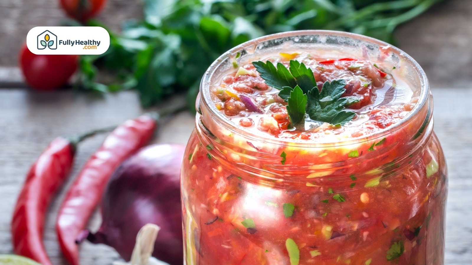 Jar of vibrant salsa with herbs and spicy chili peppers