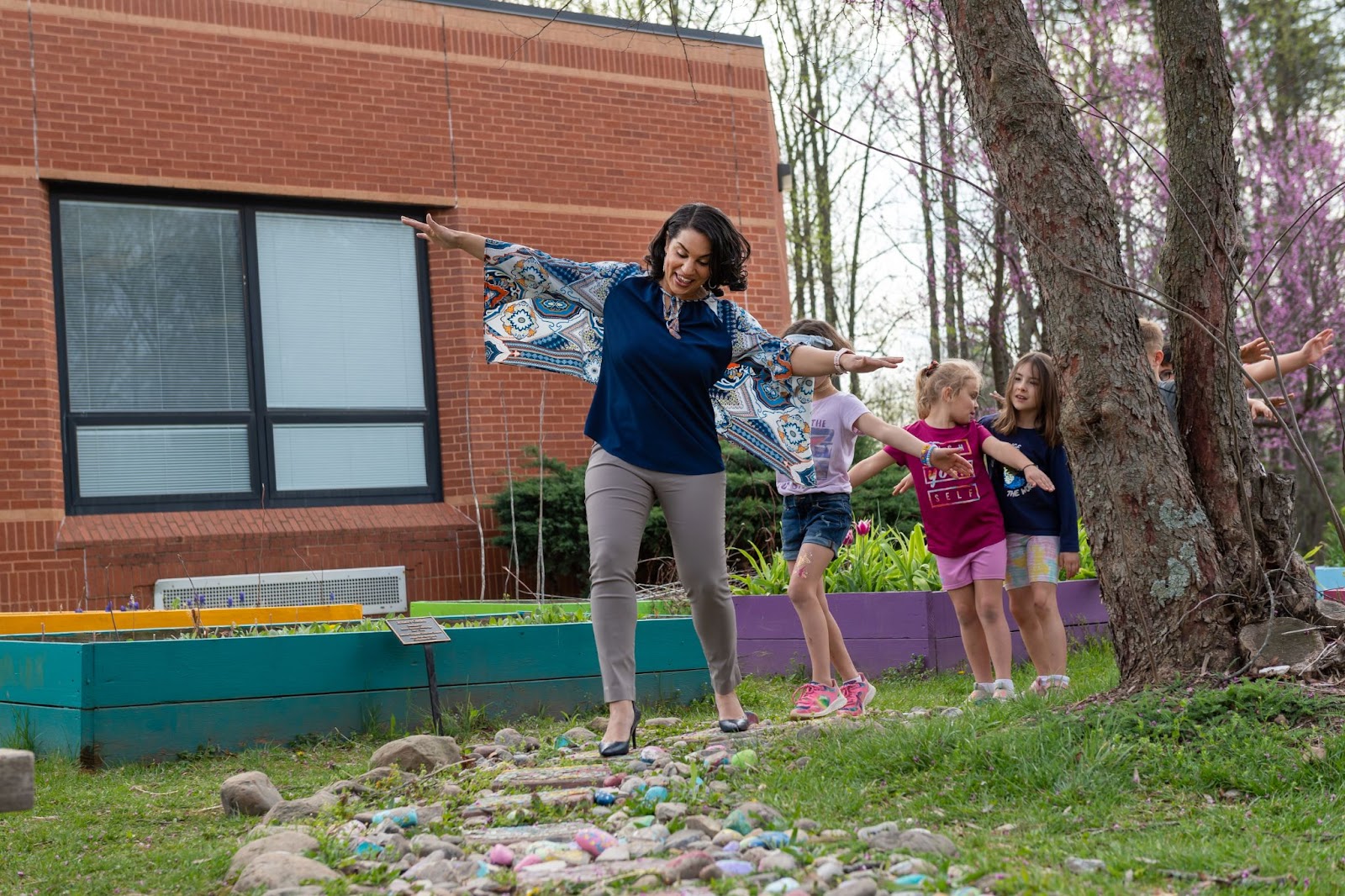 A teacher leads students down a footpath