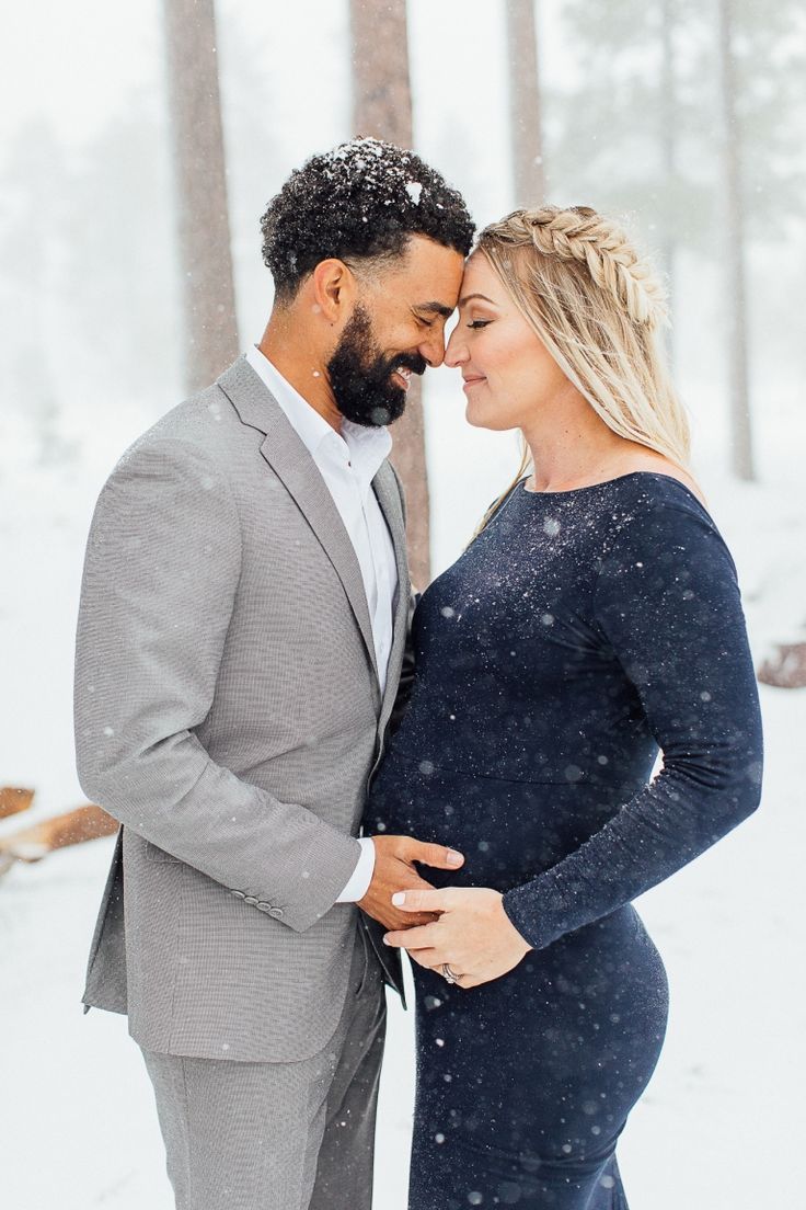 Snow-kissed love: Expecting parents embracing the cold in a heartwarming winter maternity shoot.