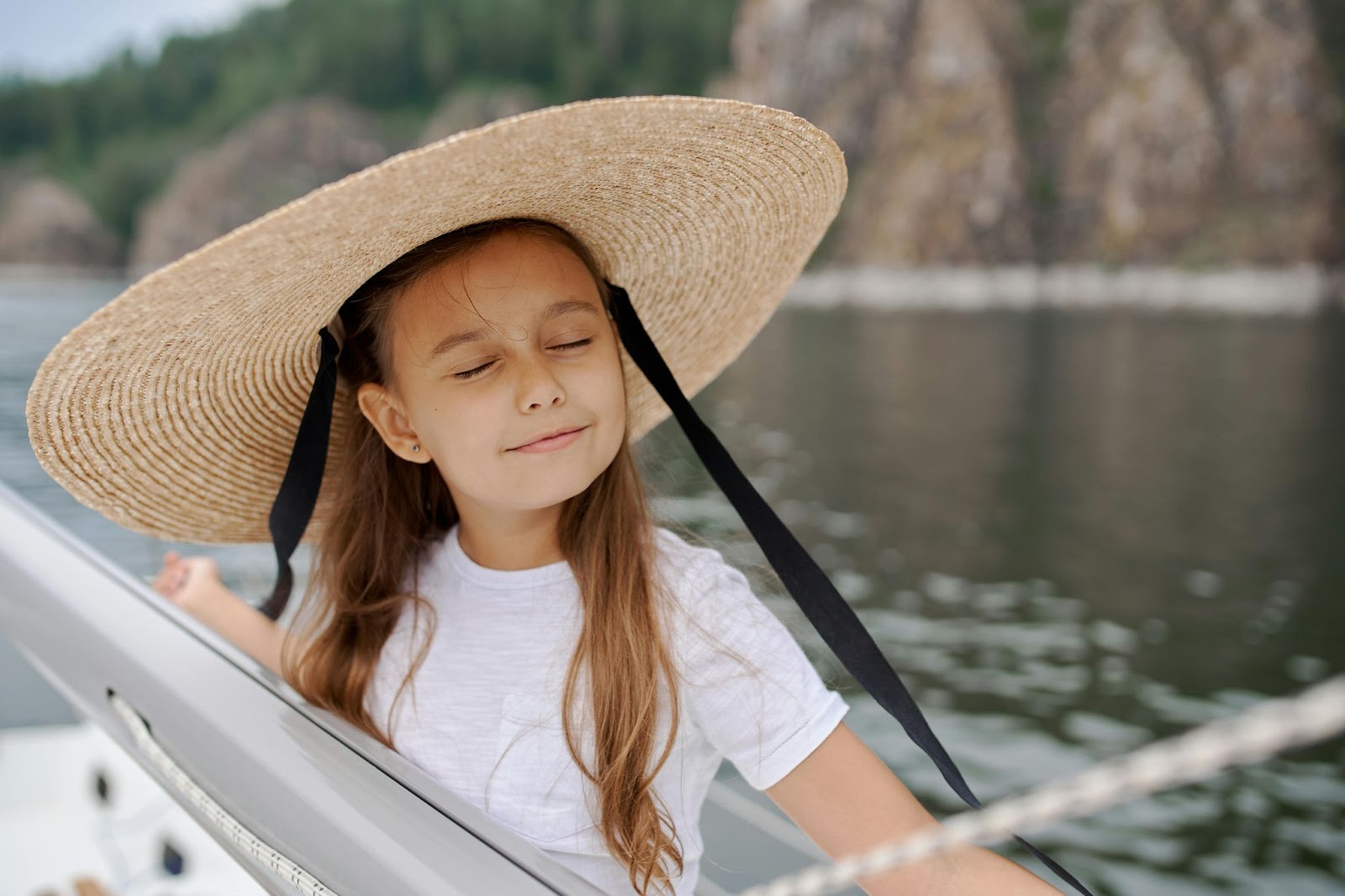 Little girl in hat on a yacht