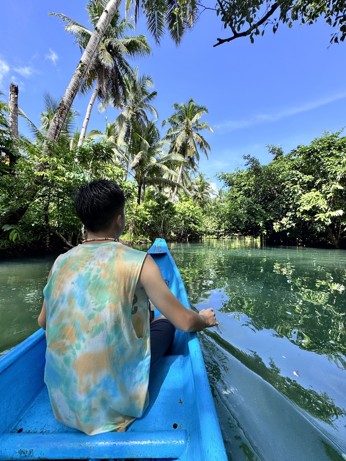 A boy riding a boat in Maasin river