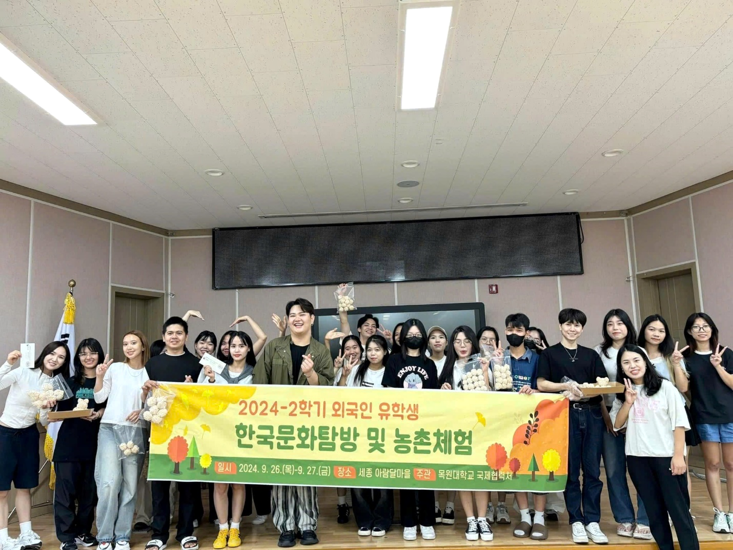 A group of people holding a banner

Description automatically generated