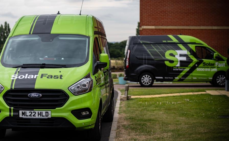 A green van parked on the side of a road

Description automatically generated