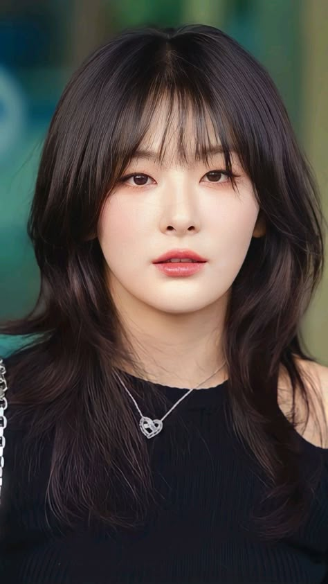 This contains an image of Seulgi  Red Velvet on a black dress wearing a necklace