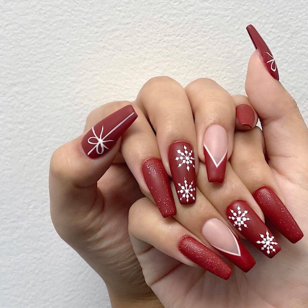 Festive Christmas nail designs featuring red and green nails with glitter accents, snowflakes, and holiday-themed nail art.