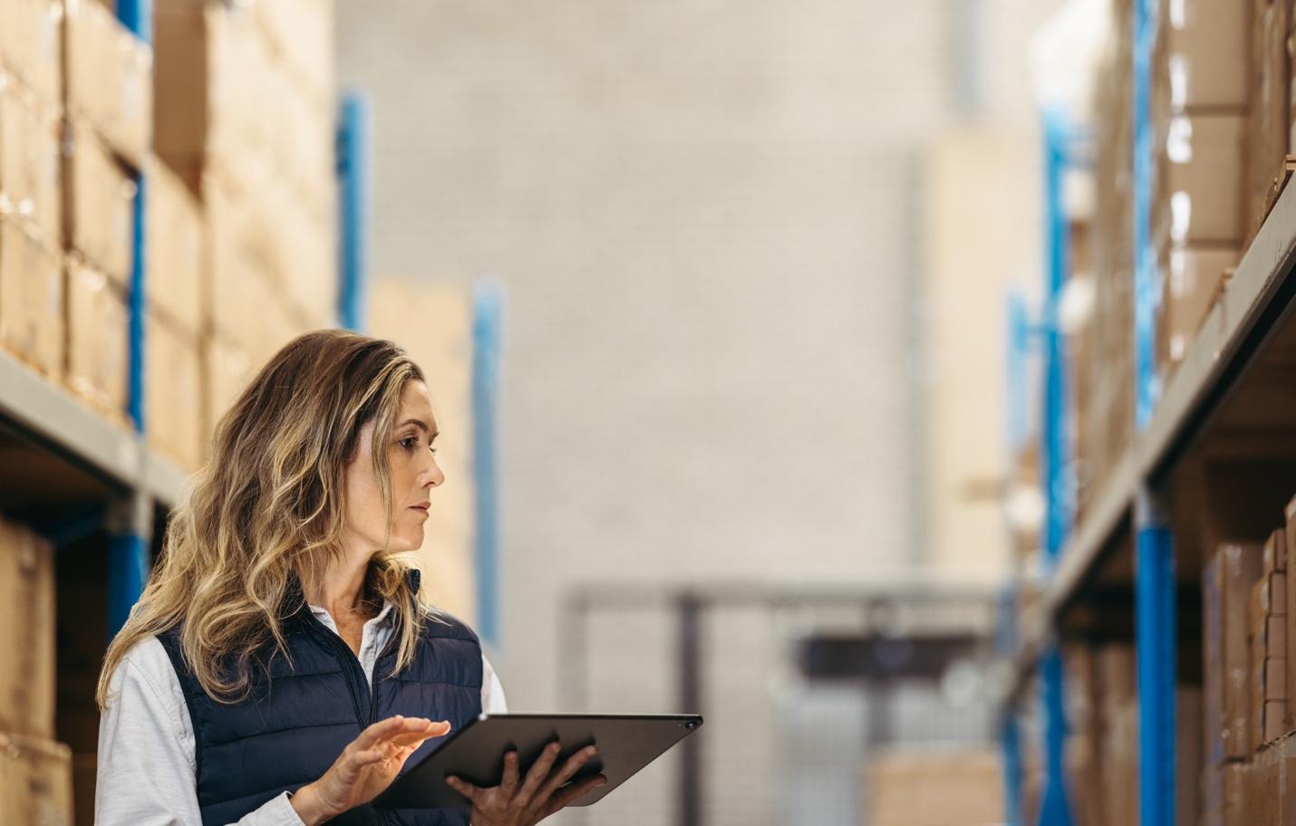 Woman with tablet in warehouse