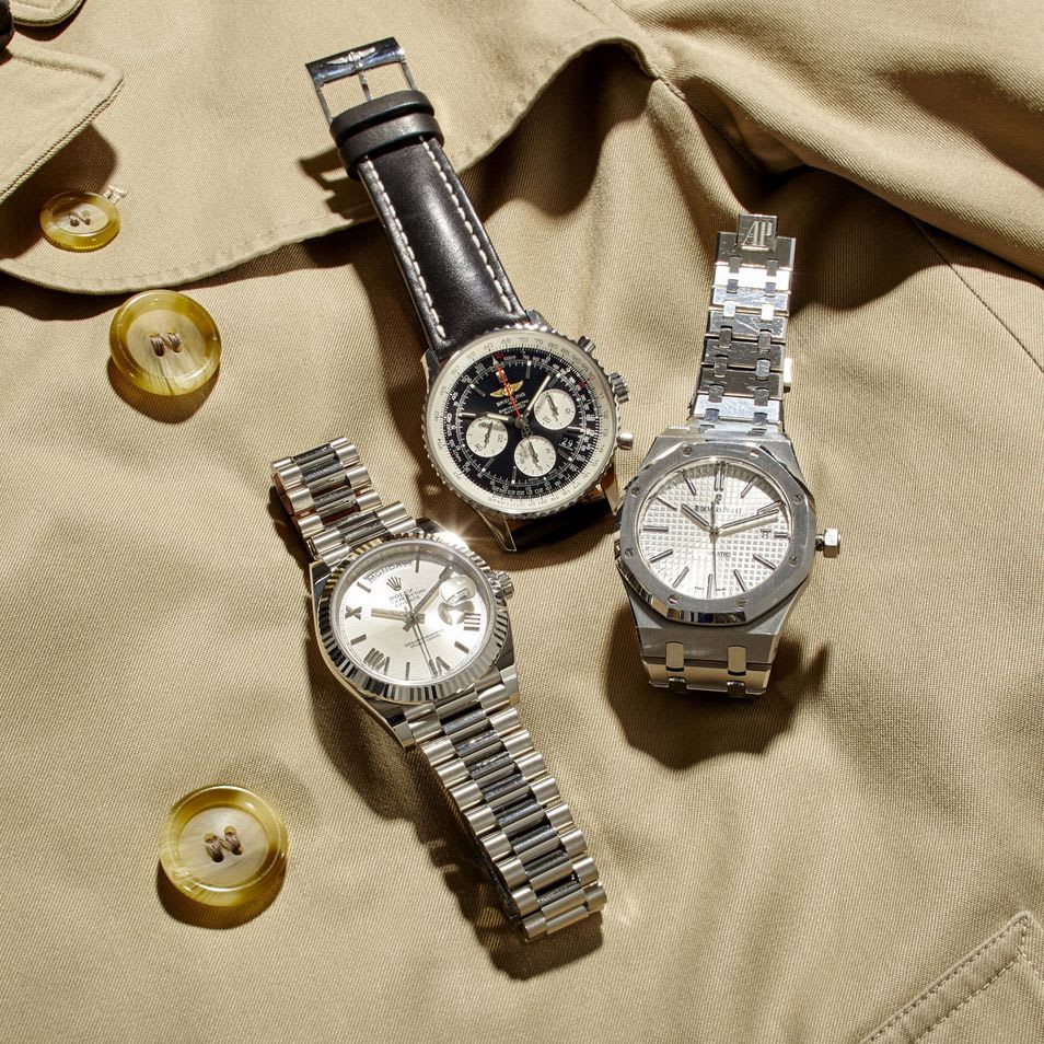 Three luxury watches including Rolex, Breitling, and Audemars Piguet displayed on fabric, illustrating examples of high-end timepieces relevant to verifying authenticity