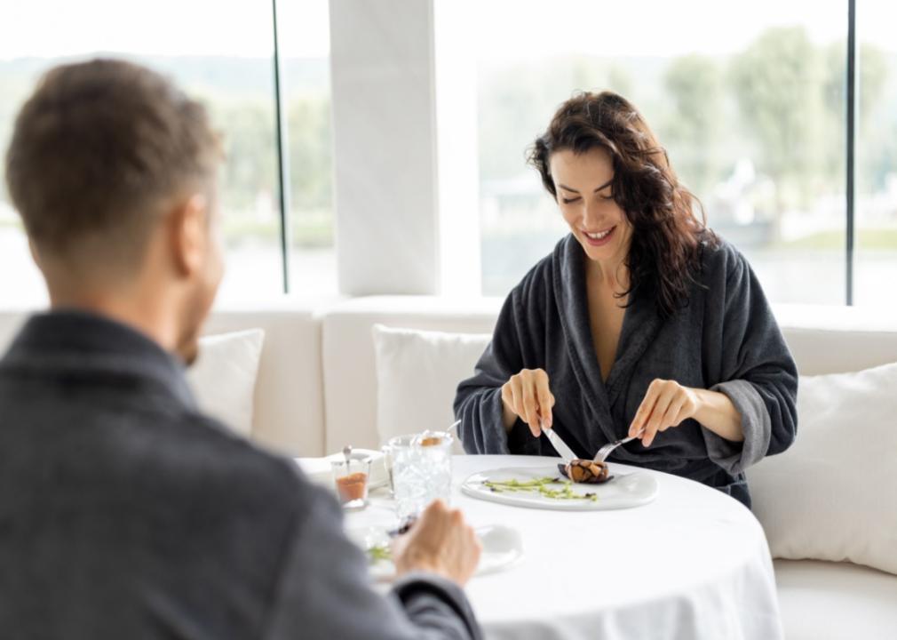 Two people dining in robes.